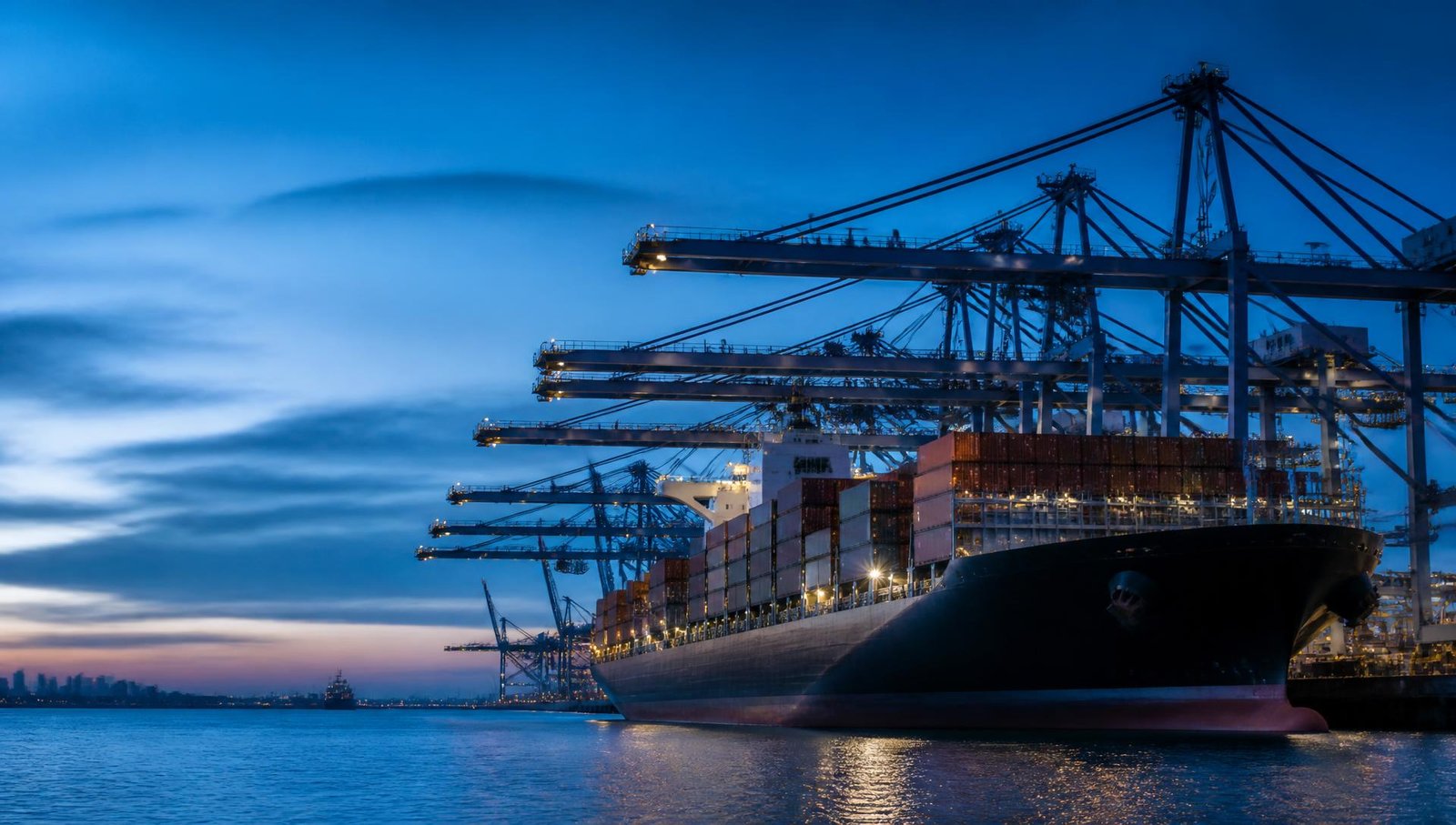 Container vessel berthed at a port terminal at dusk